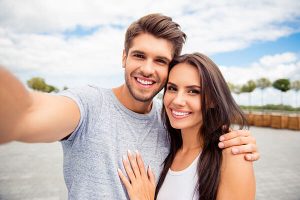 young couple smiling outdoors
